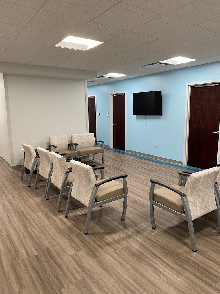 Rehab facility common area with seating and television.