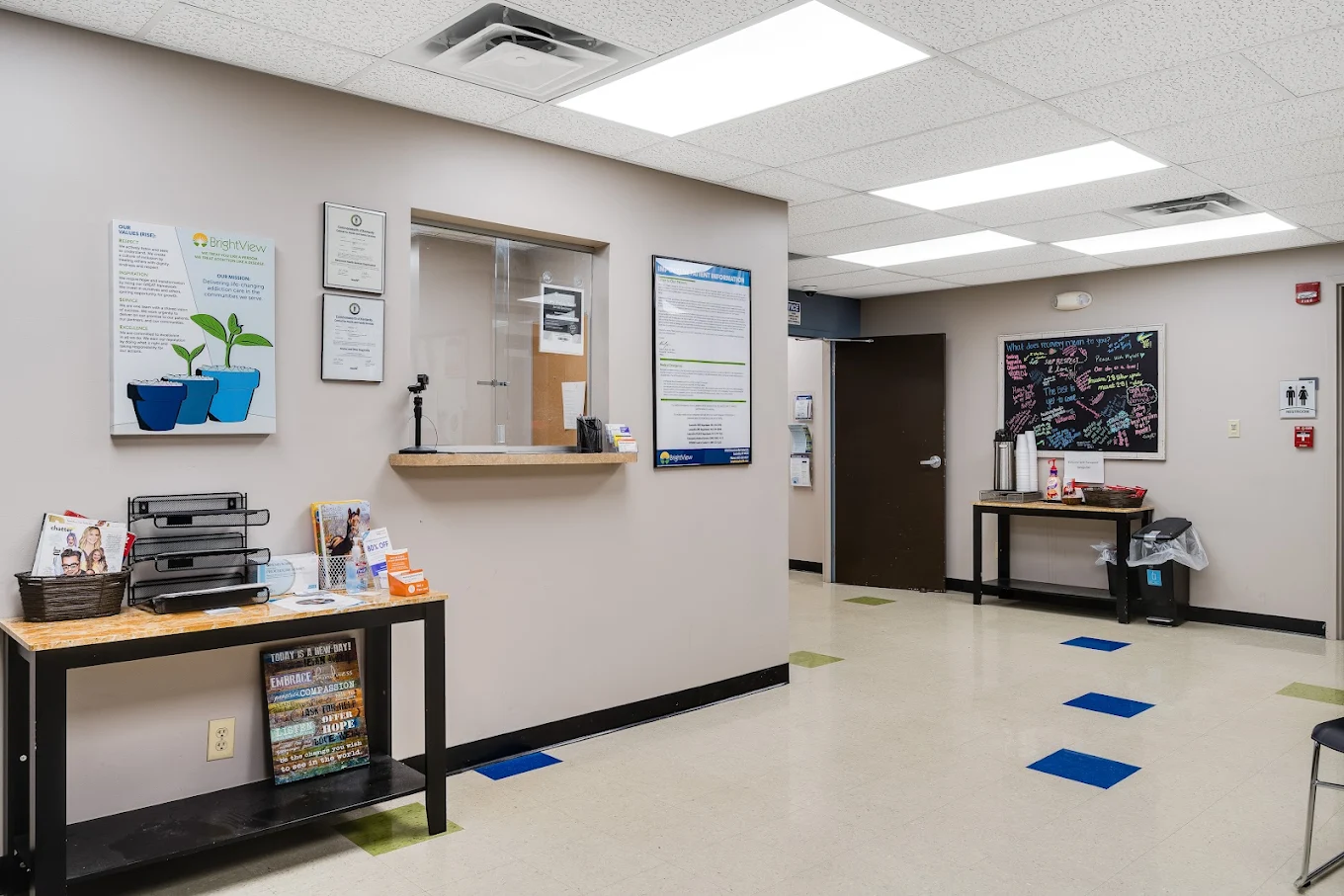 Reception area with service window and patient information displays