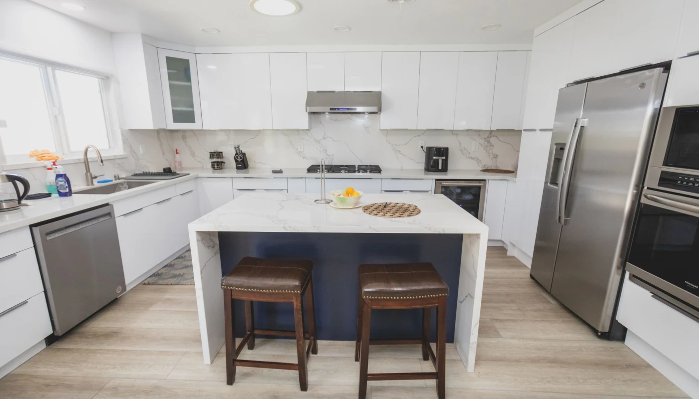 White modern kitchen with island and barstools