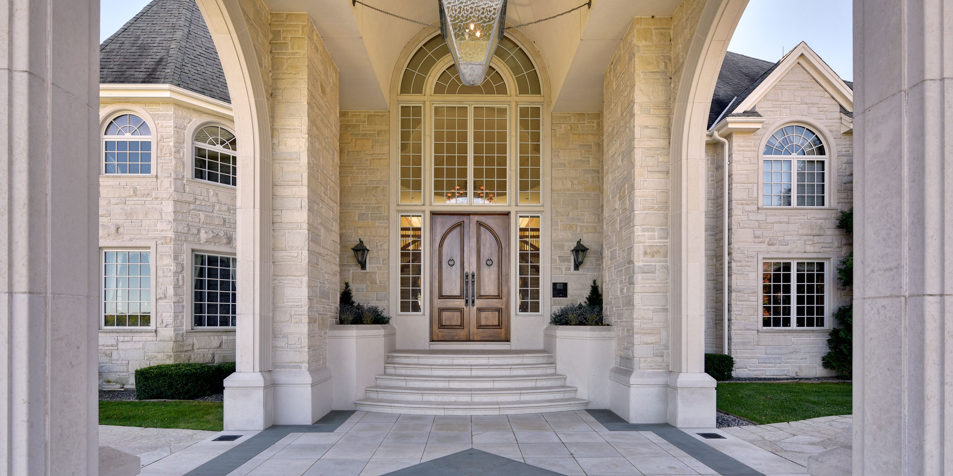 Grand stone entrance with double wooden doors