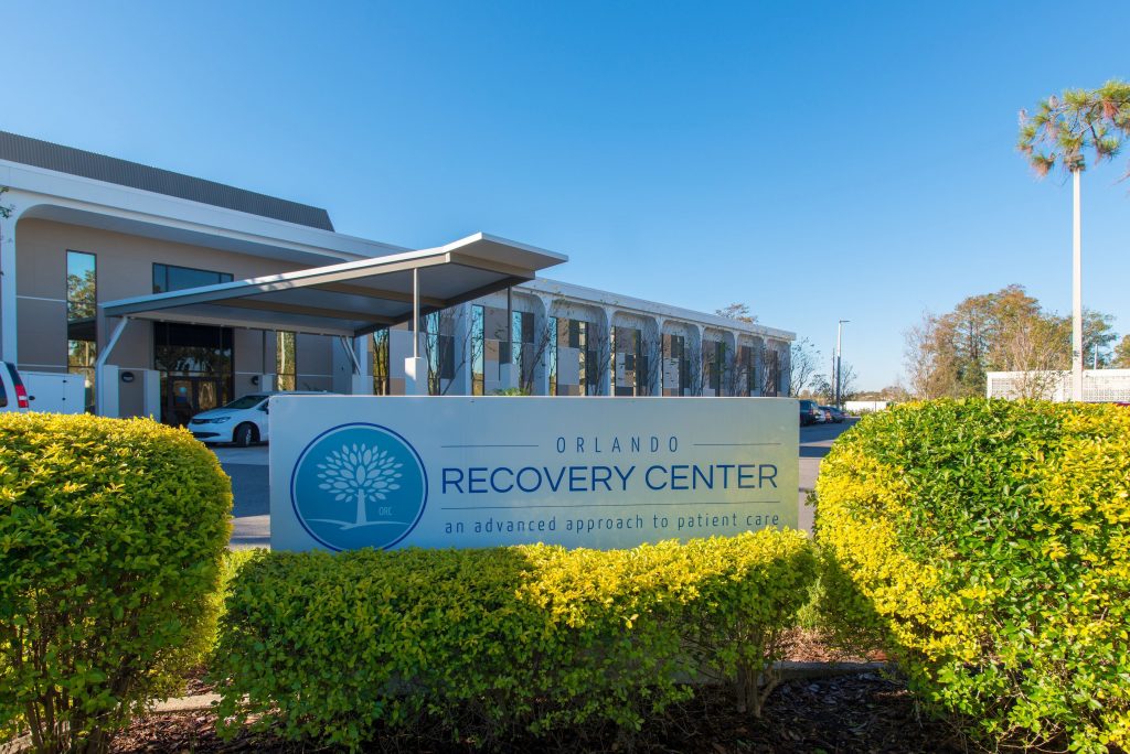 Exterior of Orlando Recovery Center with a welcoming sign and landscaping.