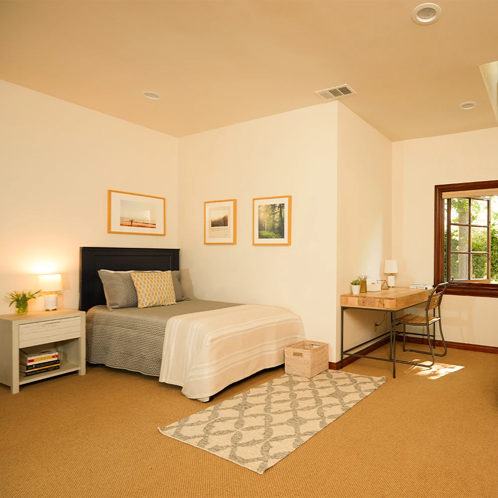 Spacious bedroom with desk and large window