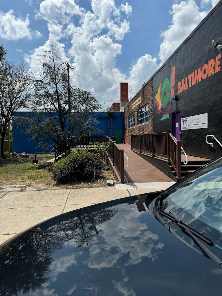 Brick rehab facility with colorful mural and ramp entrance