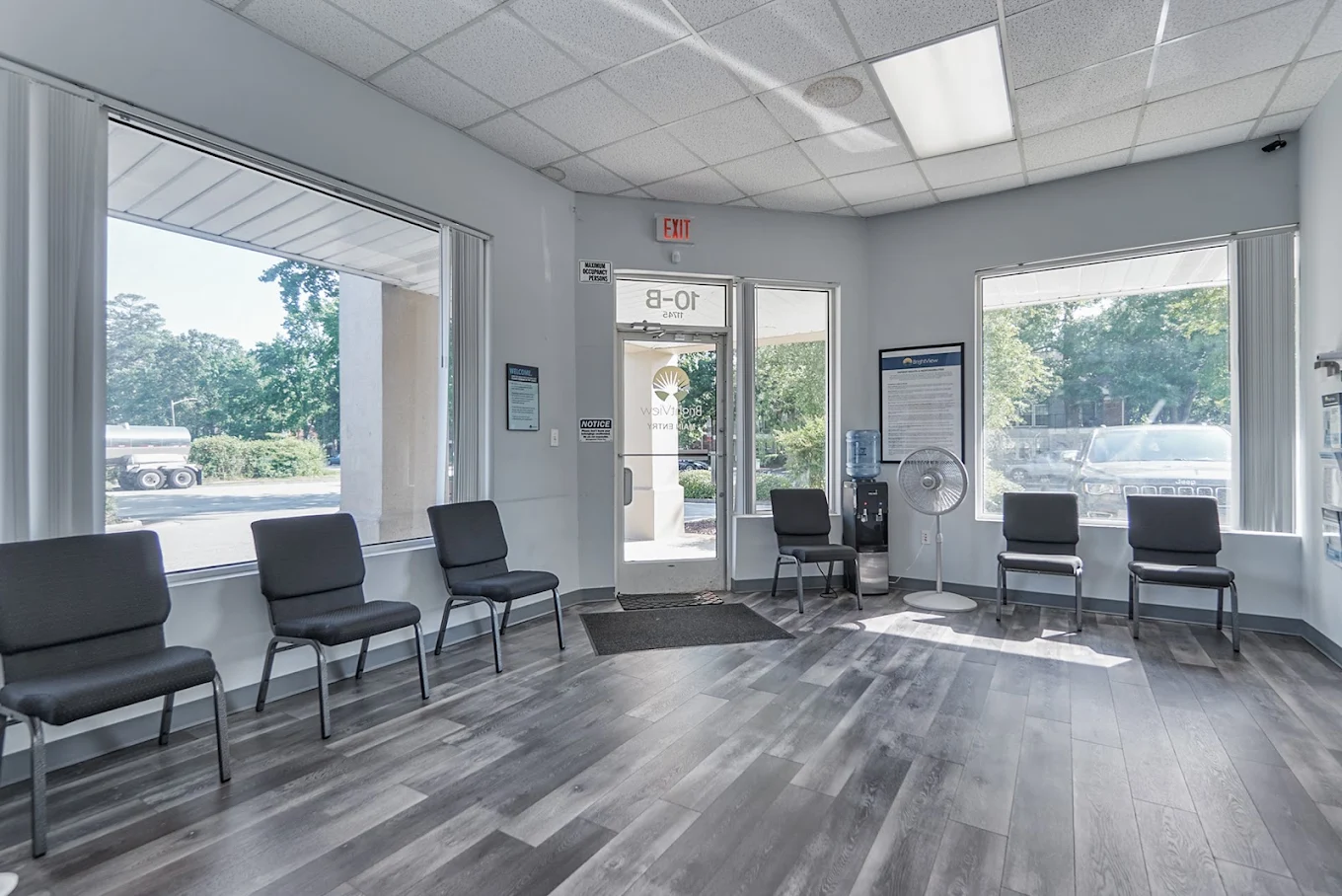 Bright waiting room with chairs arranged near large windows