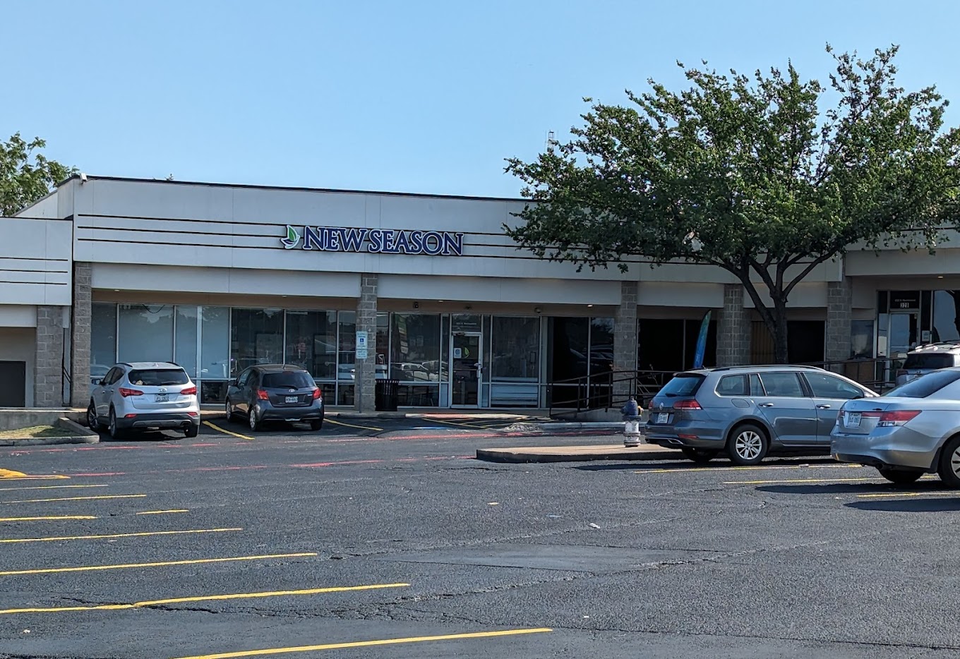 Facility exterior with parking lot and trees.