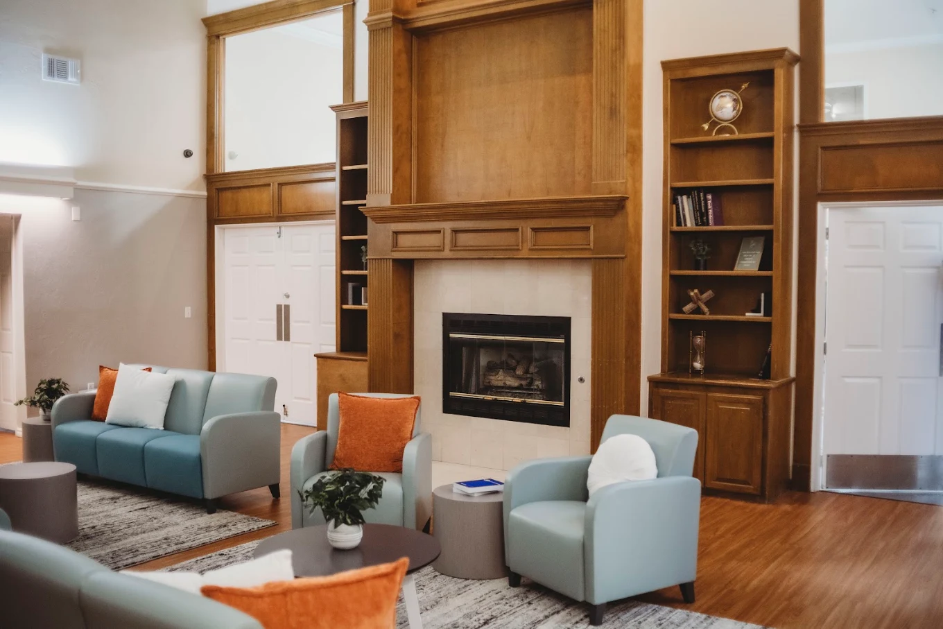 Lounge seating area with fireplace and built-in wood shelving
