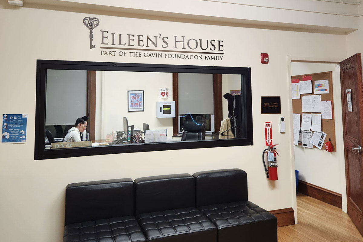 Reception window with staff and “Eileen’s House” sign