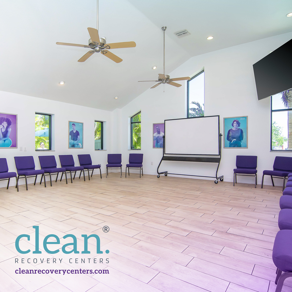 Bright therapy space with purple chairs and a large whiteboard