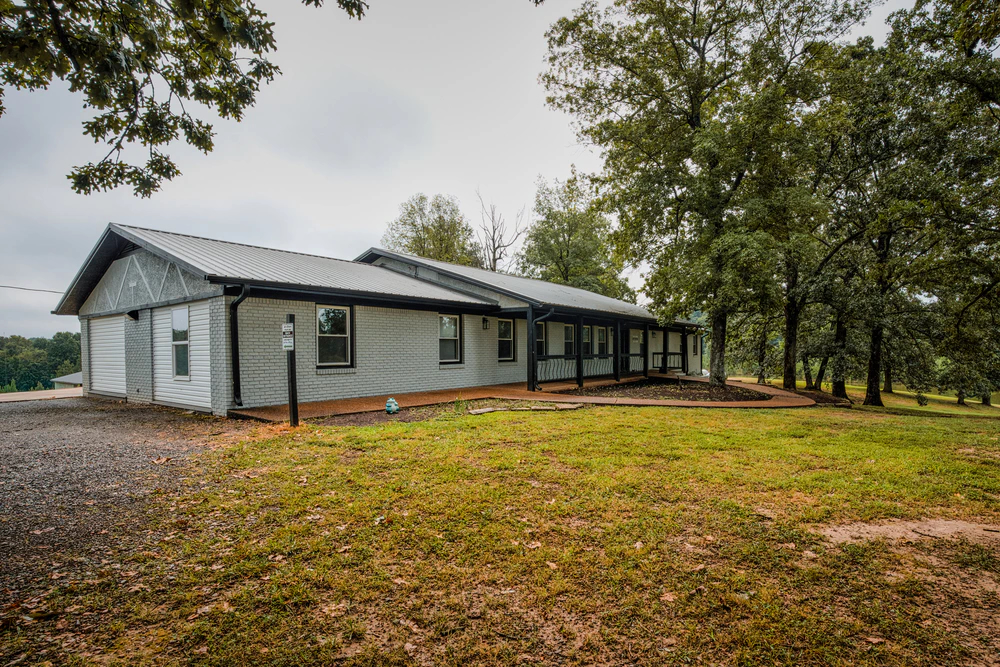 Single-story residential treatment center surrounded by trees