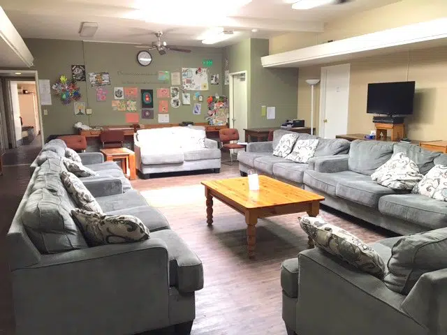 Lounge with sofas, coffee table, and TV at Janus of Santa Cruz.