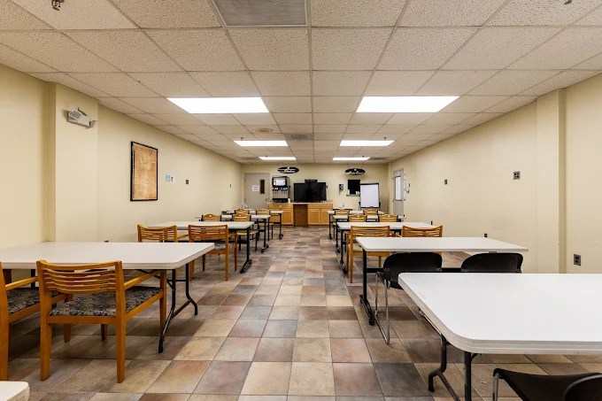 Room with tables and chairs for dining or group activities