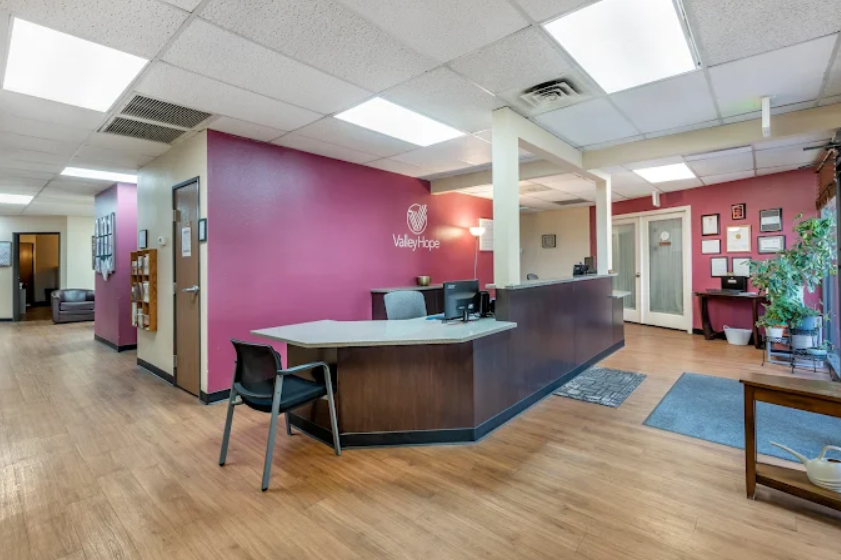 Front desk reception area with seating and wood flooring