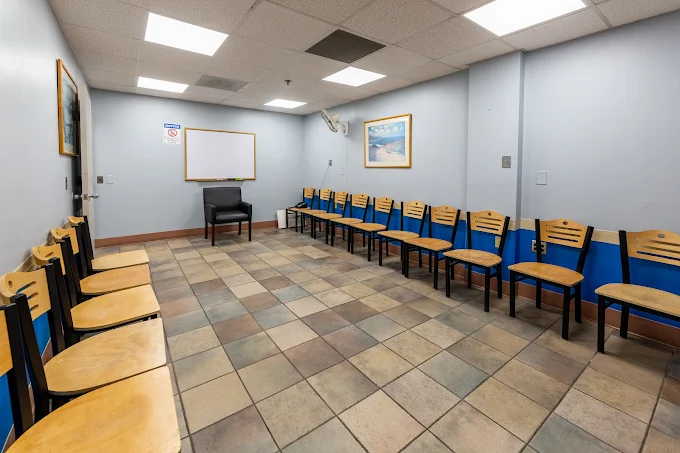 Classroom-style room with tables and chairs arranged in rows