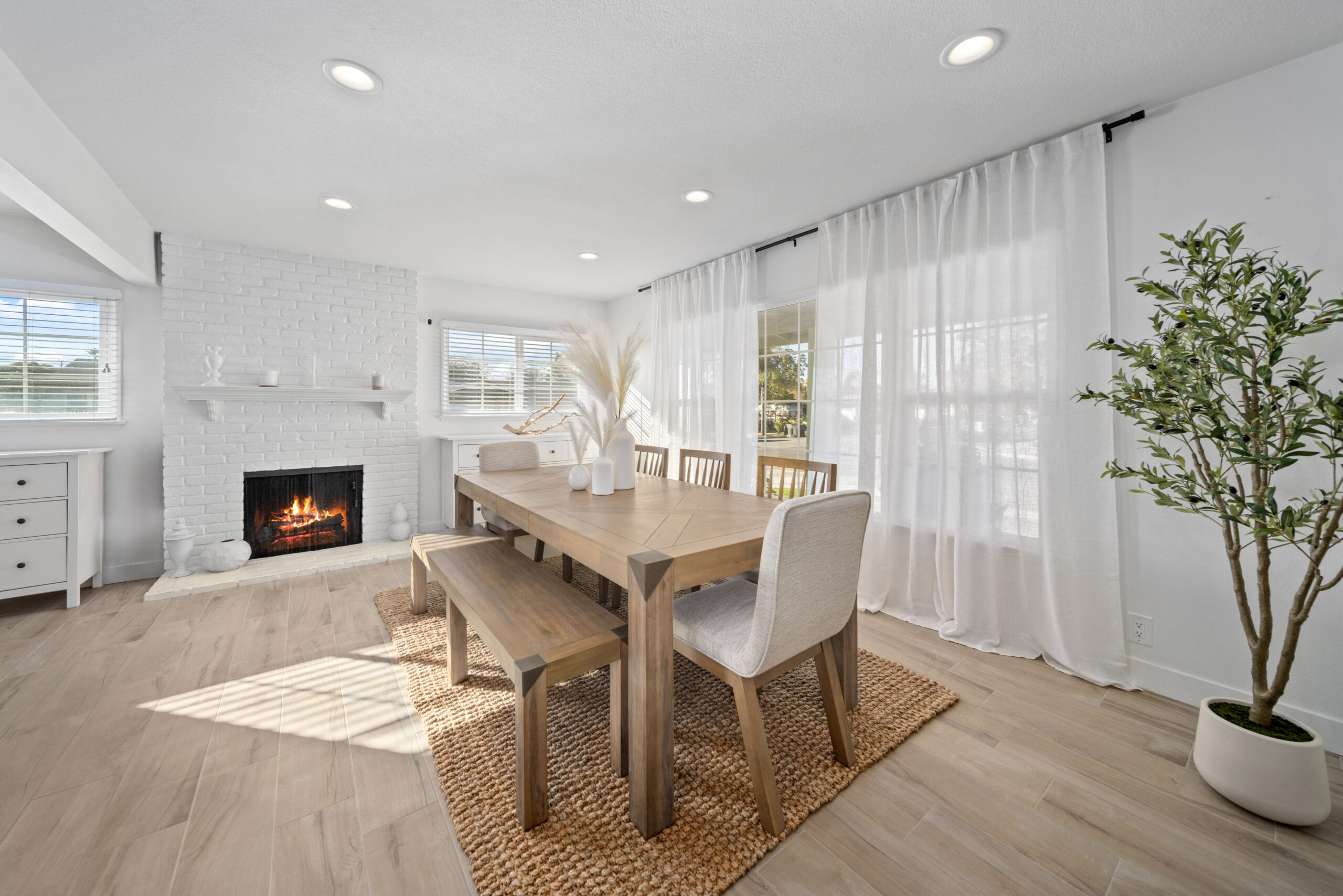 Modern dining room with wood table and white brick fireplace