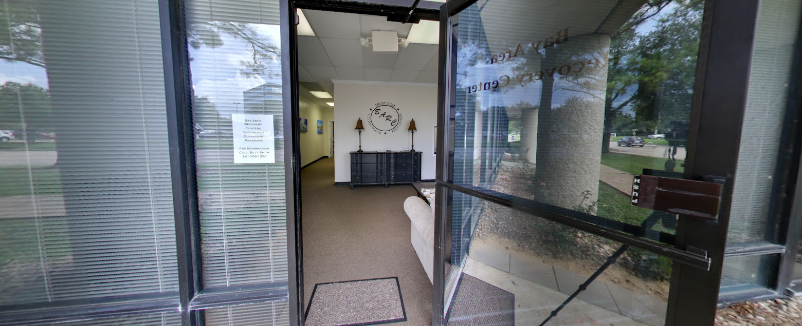 Open glass door leading into facility lobby