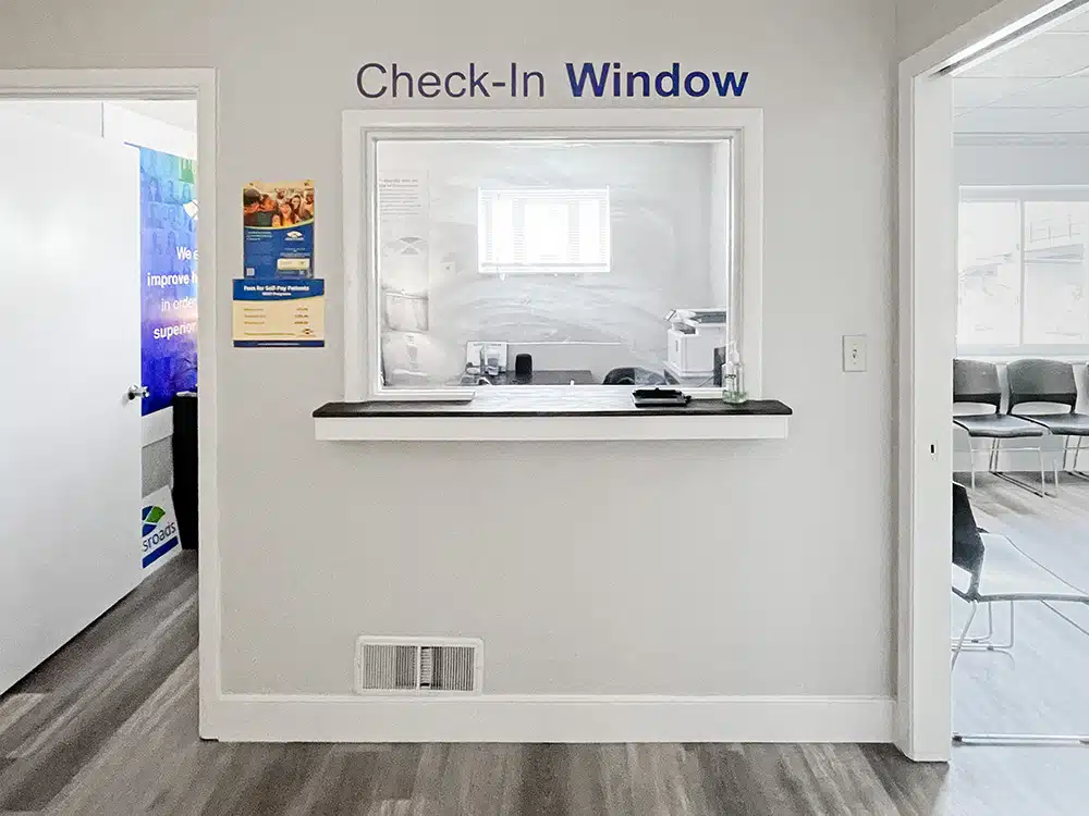 Check-in window with open doorways on both sides