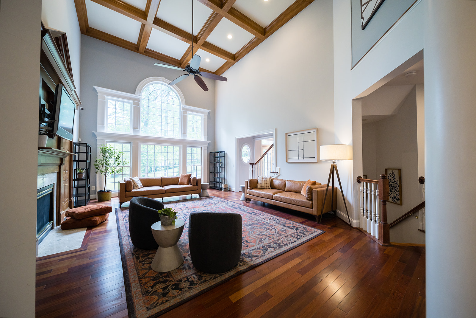 Spacious living room with tall windows and wood beams