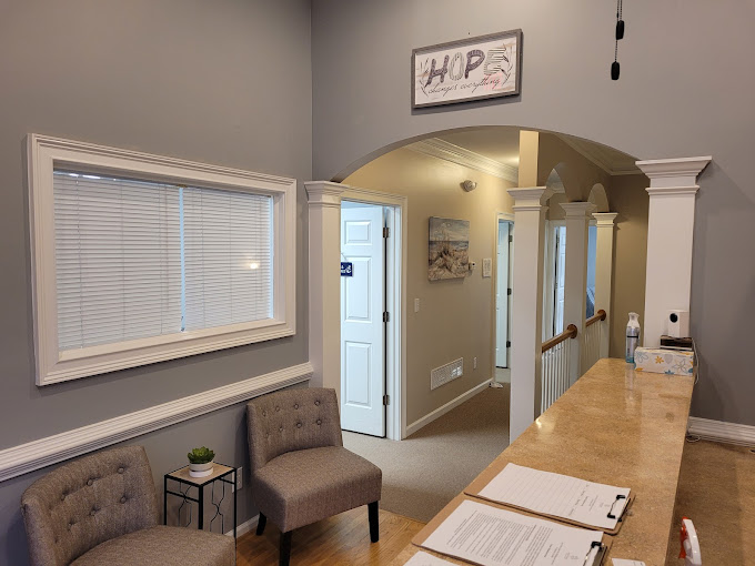 A reception area with an arched entryway and a seating nook.