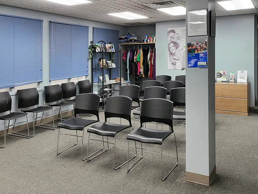 Waiting area with chairs and coat rack at clinic