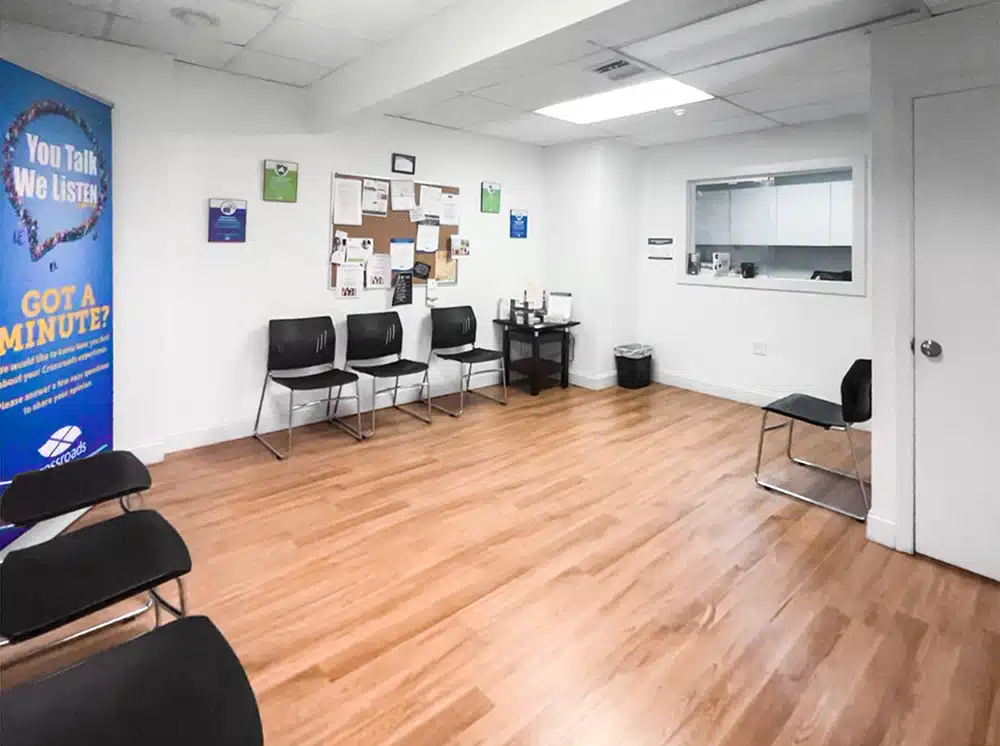 Waiting area with chairs, bulletin board, and service window