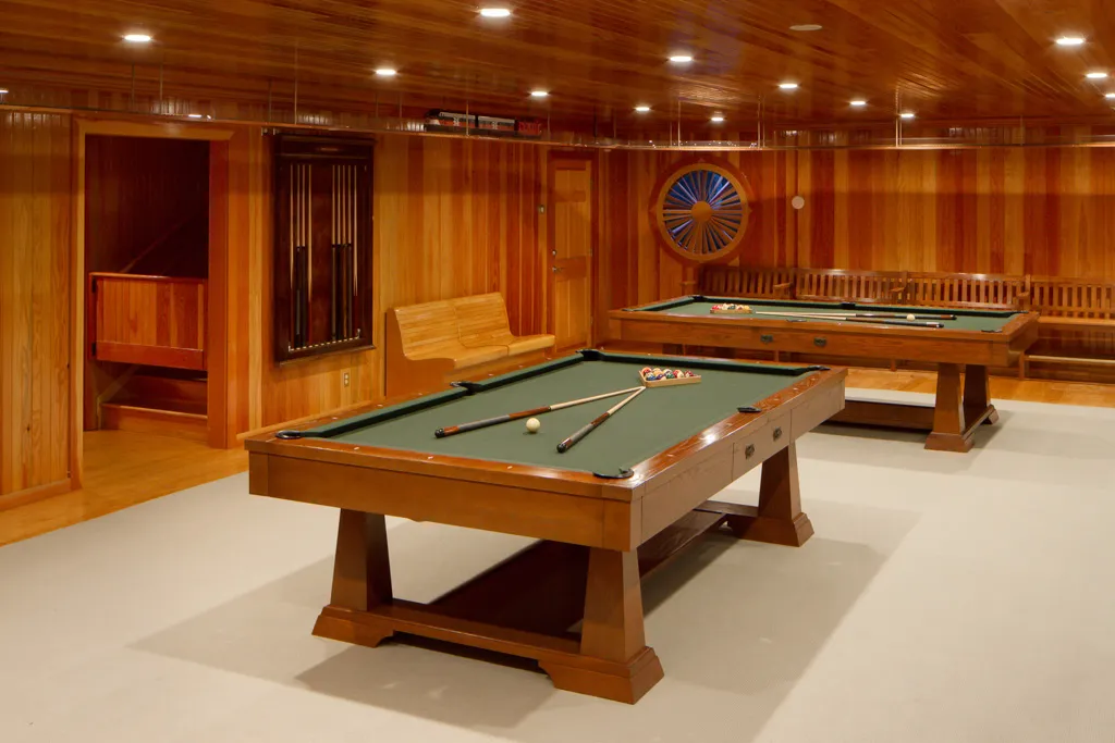 Billiards room with pool tables and wood paneling