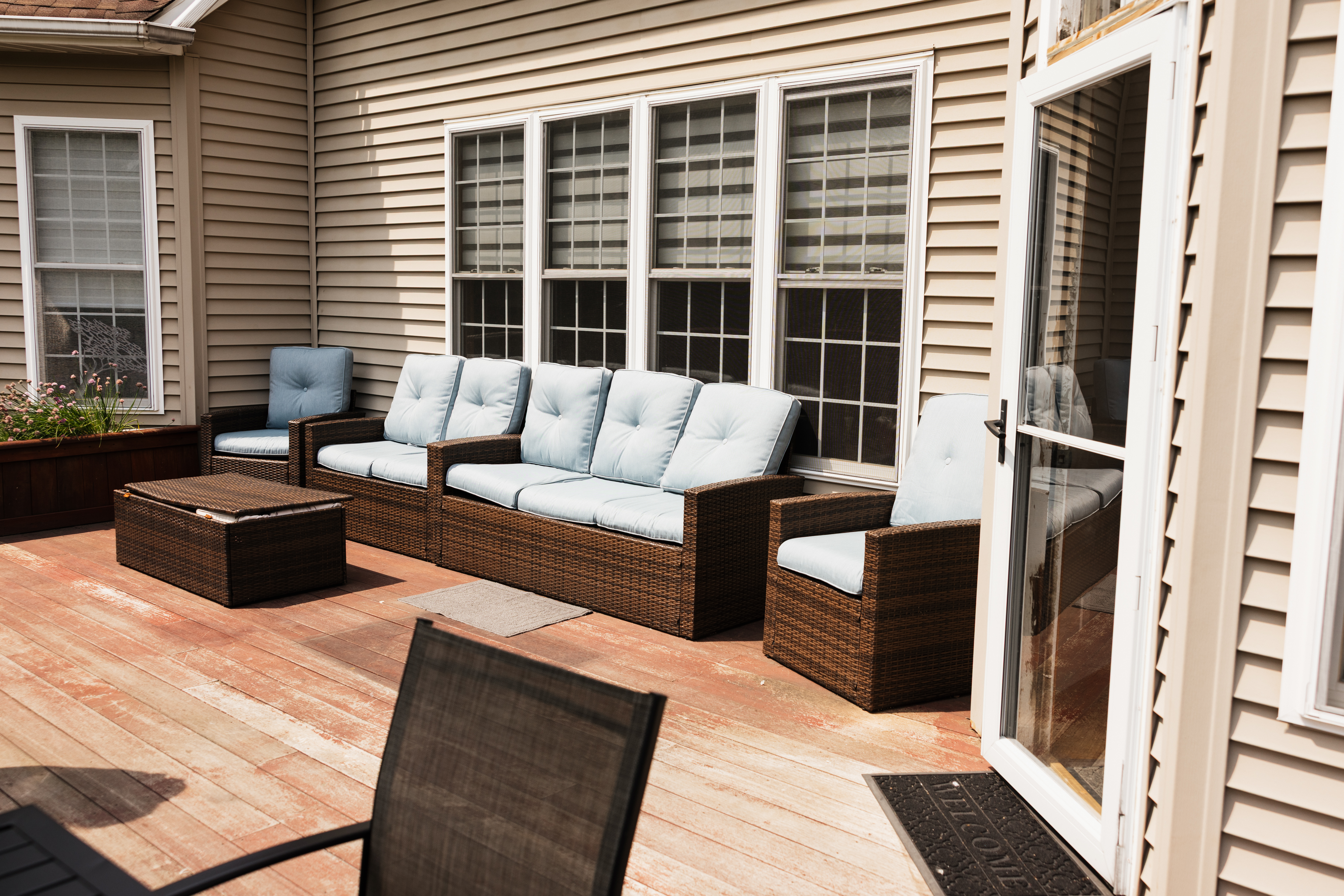 Patio with wicker furniture and blue cushions