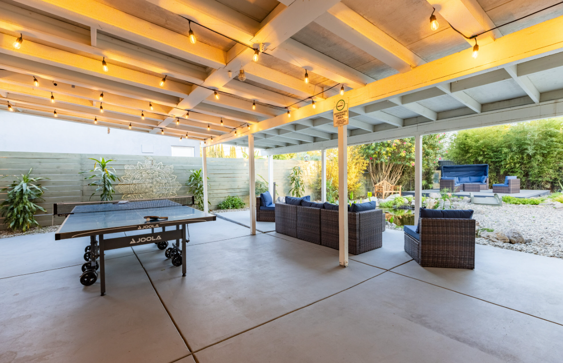 Covered patio with seating and ping pong table