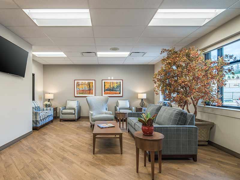 Comfortable residential lounge with sofas and seating inside treatment center