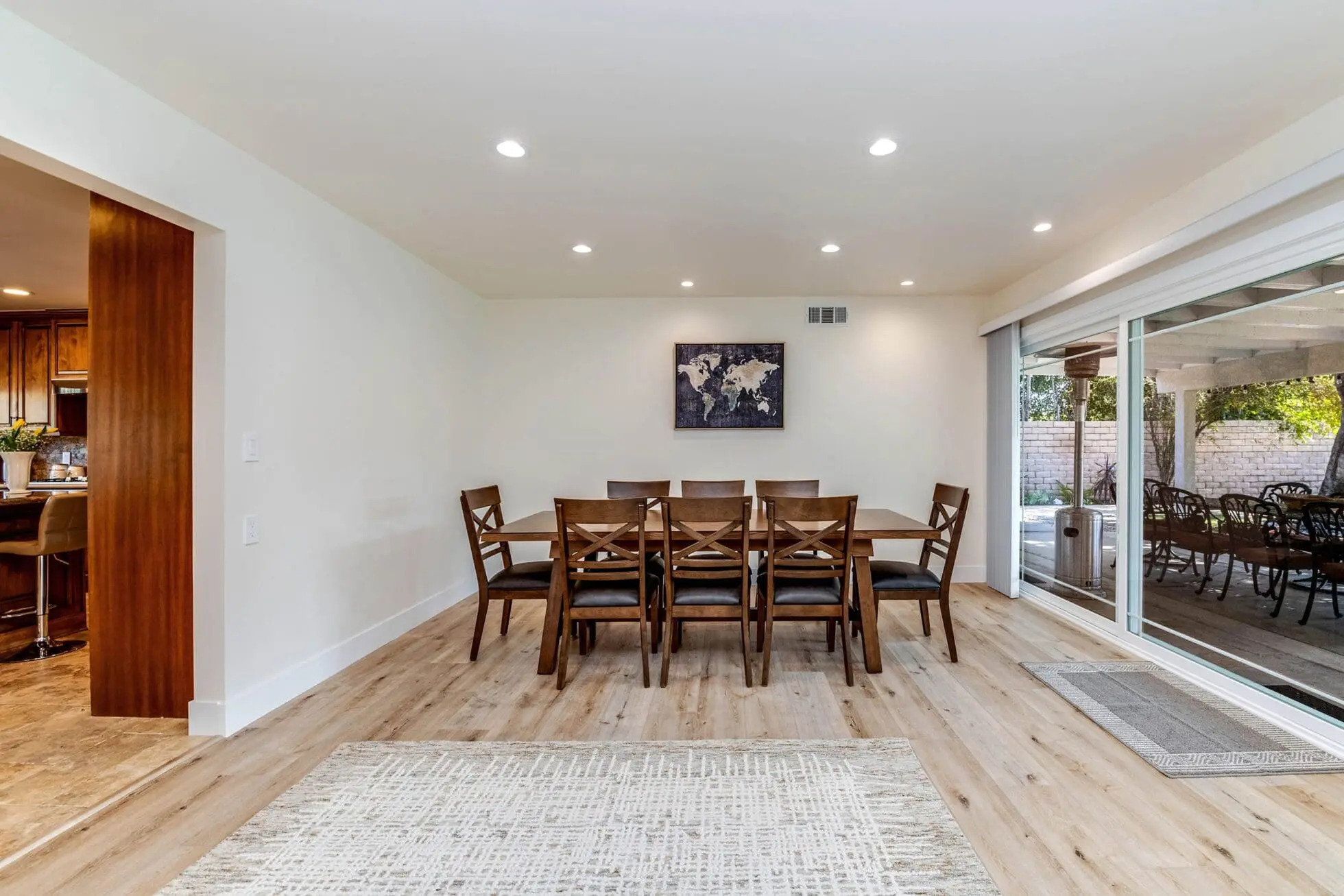 Wooden dining table beside glass sliding doors