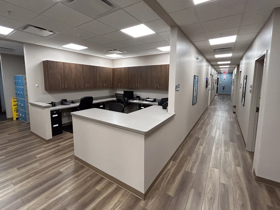 Reception station beside a hallway with treatment rooms