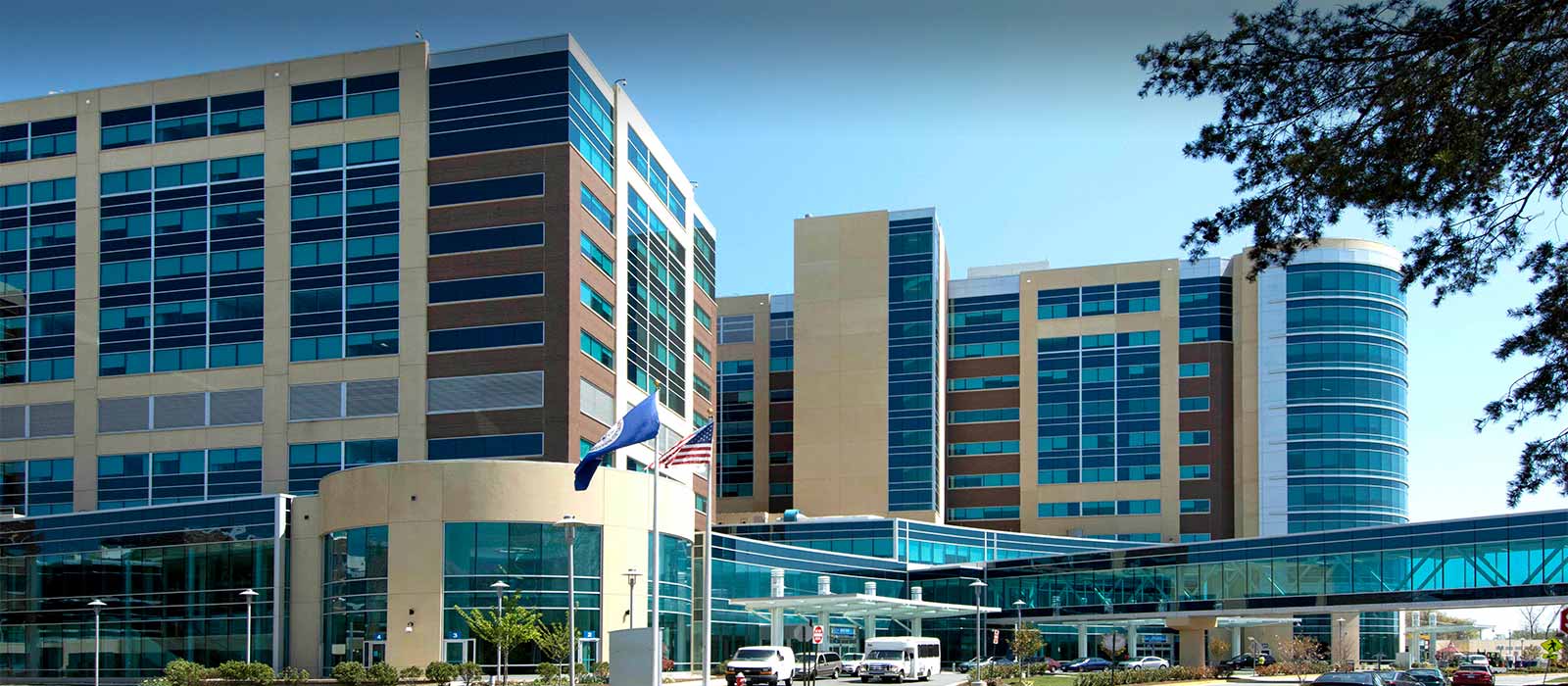 Modern multi-story hospital with skybridge and glass facade