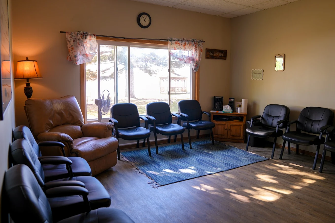 Group therapy room with chairs arranged near large windows