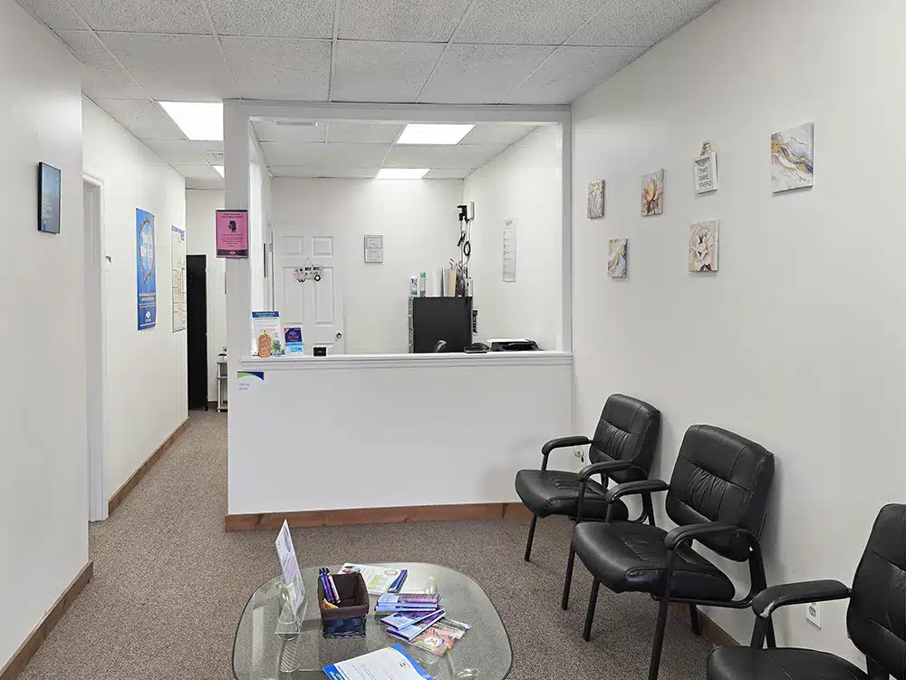Waiting area with chairs and front desk in background