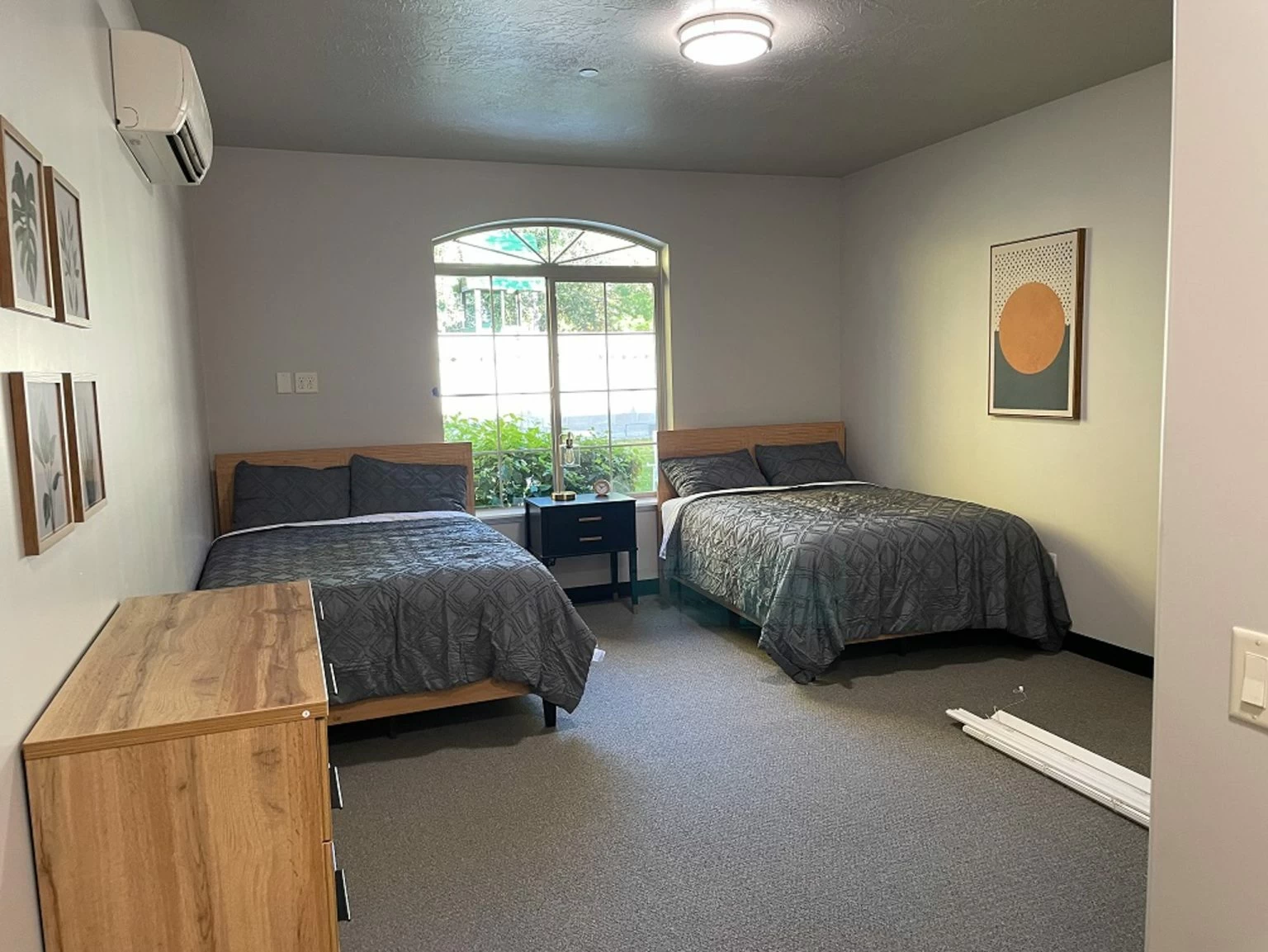 Shared bedroom with two beds and natural light