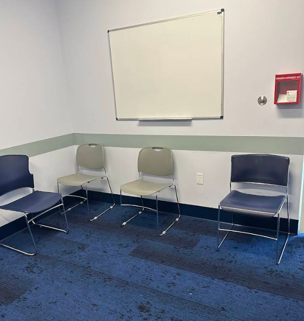 Small meeting room with chairs and a whiteboard