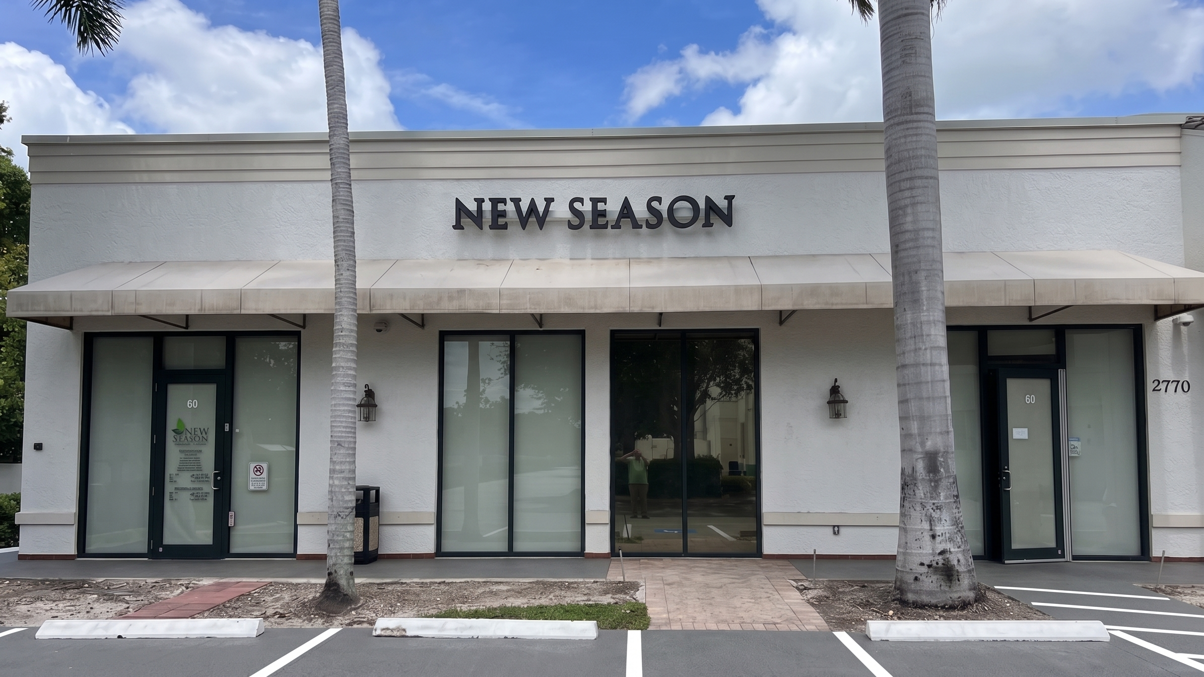 New Season treatment center entrance framed by palm trees