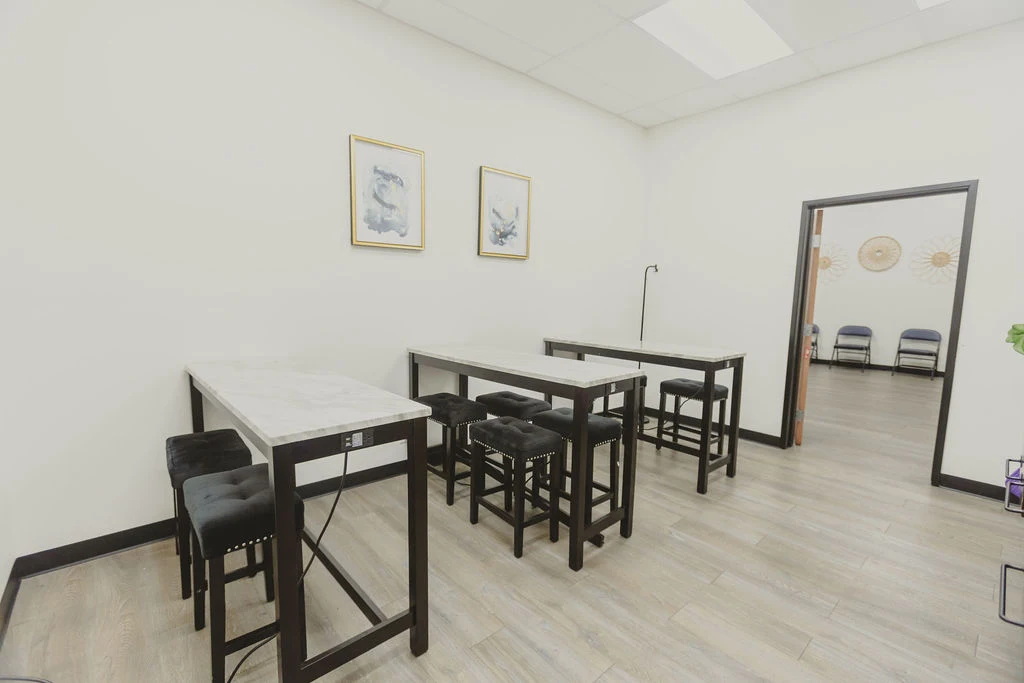 Dining area with tables and chairs on light wood flooring