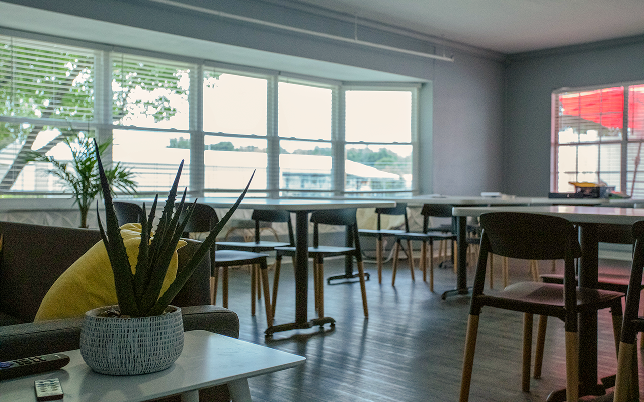 Bright, modern dining area with tables and chairs arranged near large windows