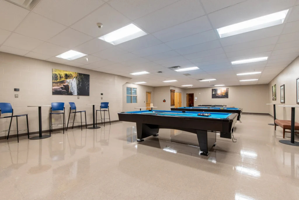 Recreation room with pool tables and wall art