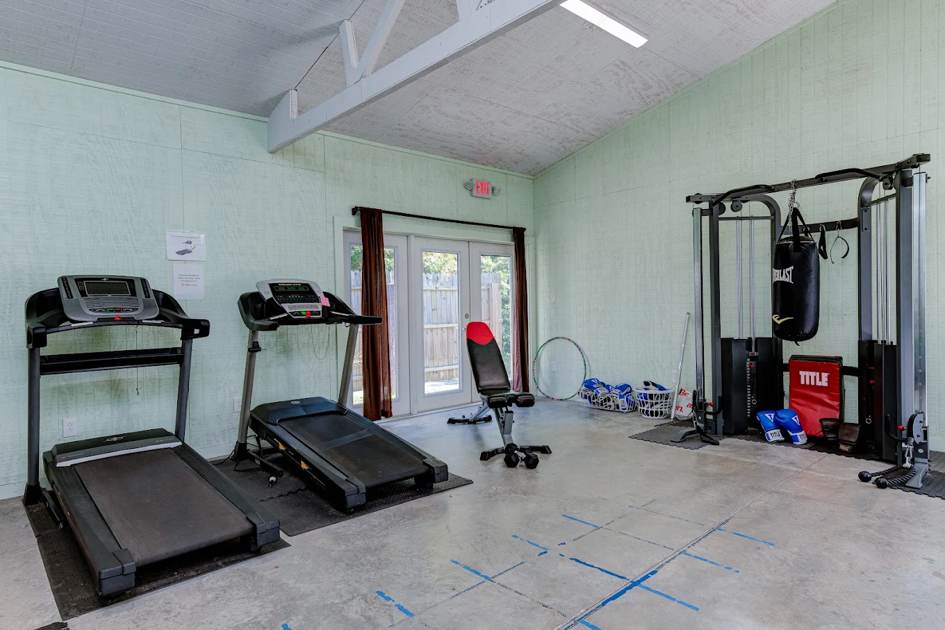 Fitness room with treadmills, weight machine and boxing equipment