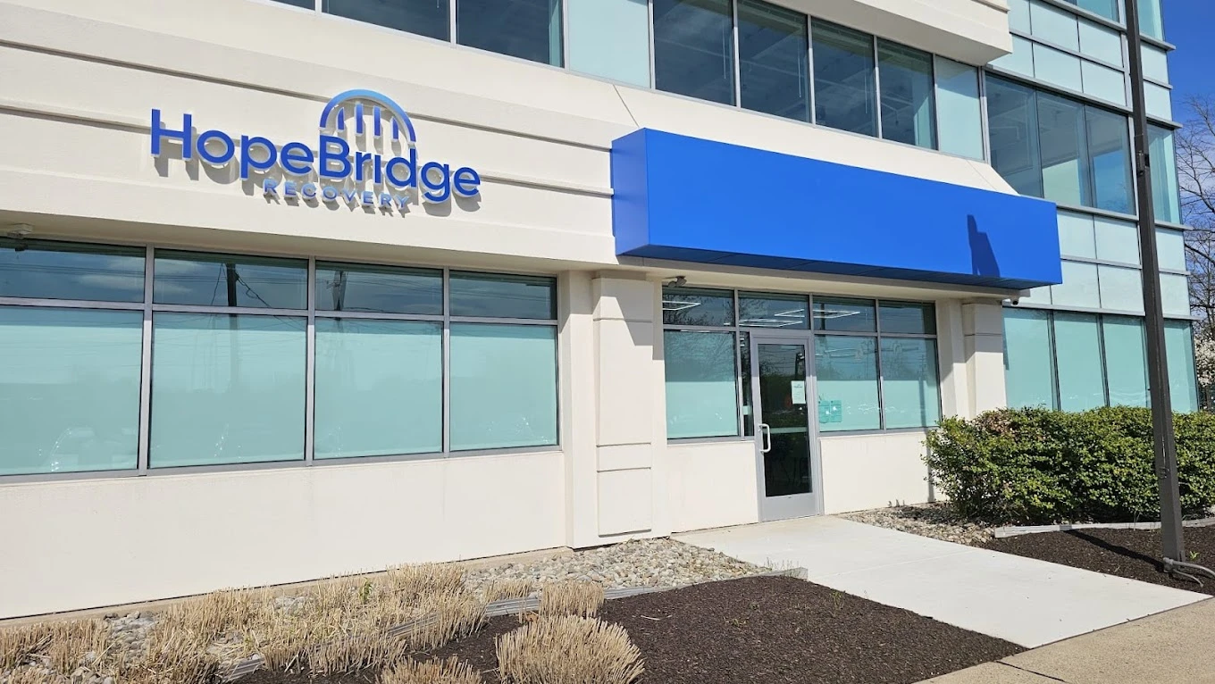 White exterior with blue awning and HopeBridge logo