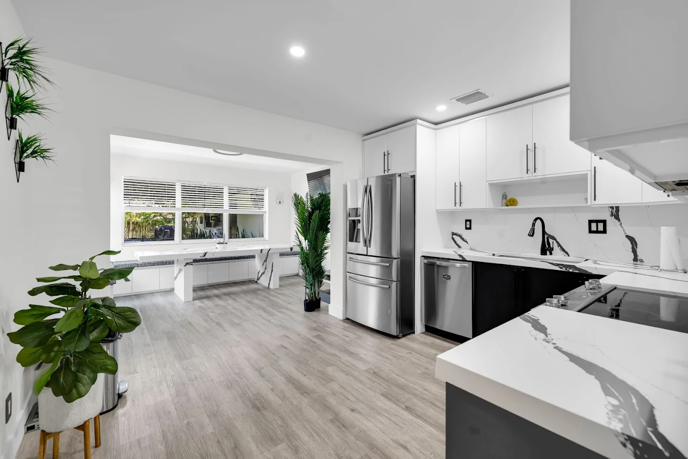 Modern kitchen with stainless appliances and dining area