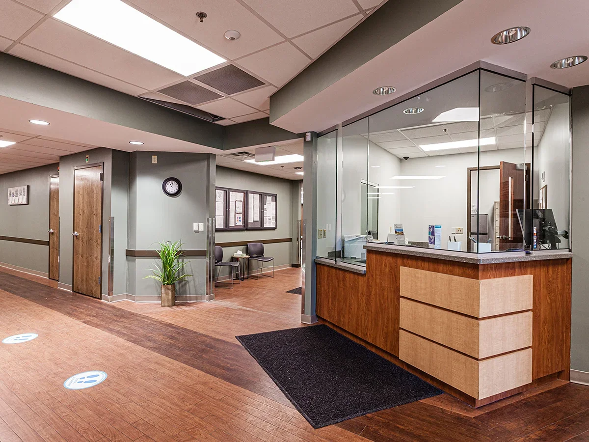 Reception desk with glass partition and check-in area