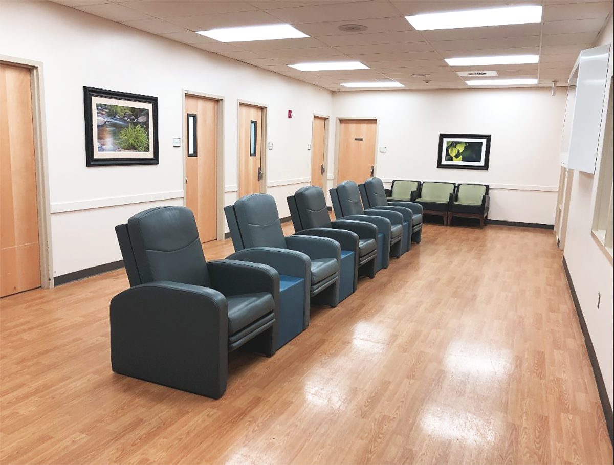 Row of chairs in admissions hallway with framed wall art