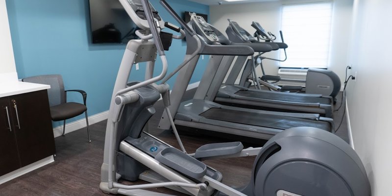  A well-equipped fitness room with treadmills and elliptical machines, providing a convenient and motivating space for staying active.