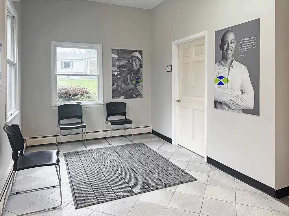 Waiting room with chairs, posters, and natural light