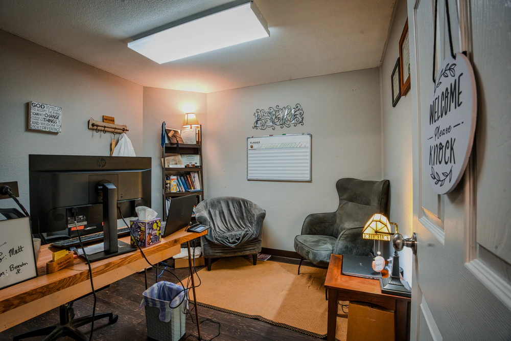 Office with computer desks, chairs, and wall decorations