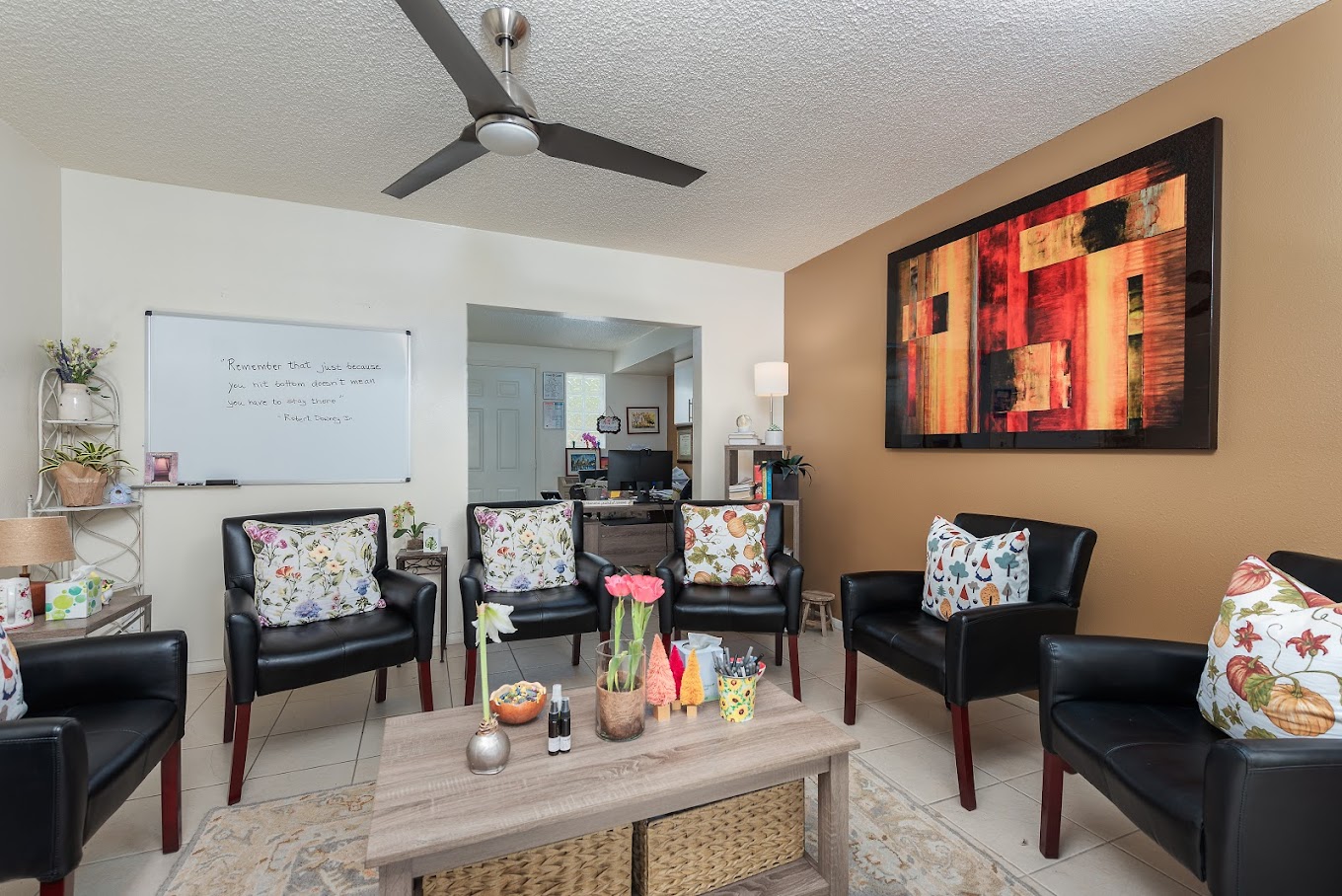 Group room with leather chairs and a large abstract painting