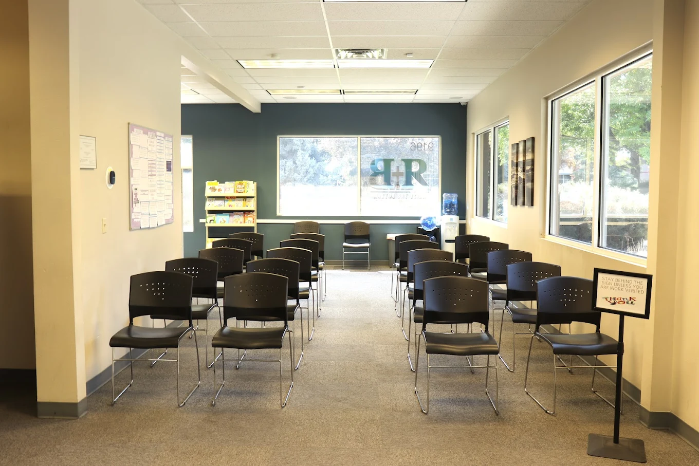 Rows of chairs arranged in a bright waiting room