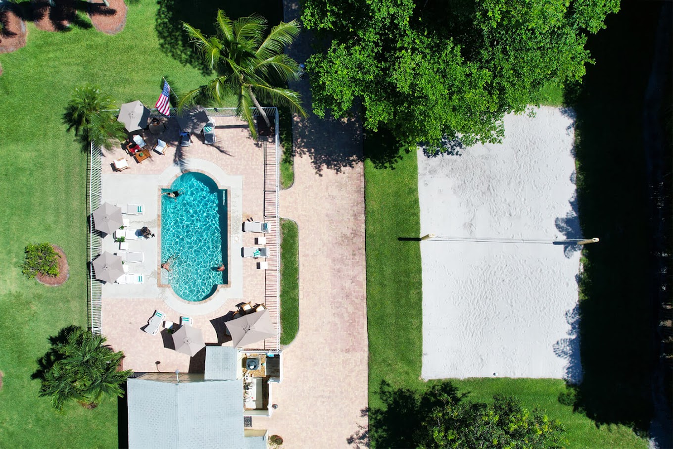 Aerial view of pool and sand volleyball court.